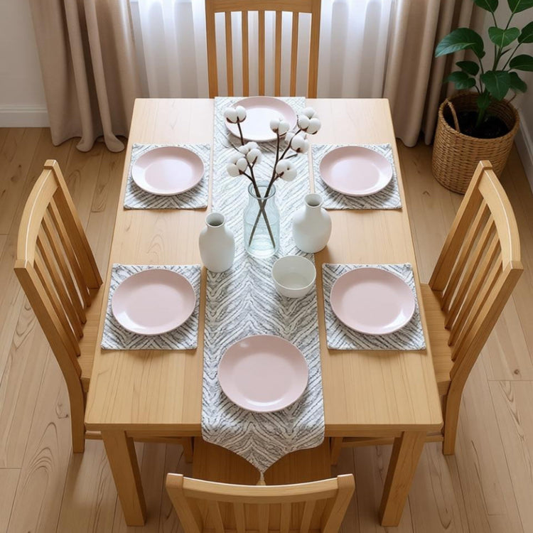 Silver chevron-pattern table runner with matching placemats.