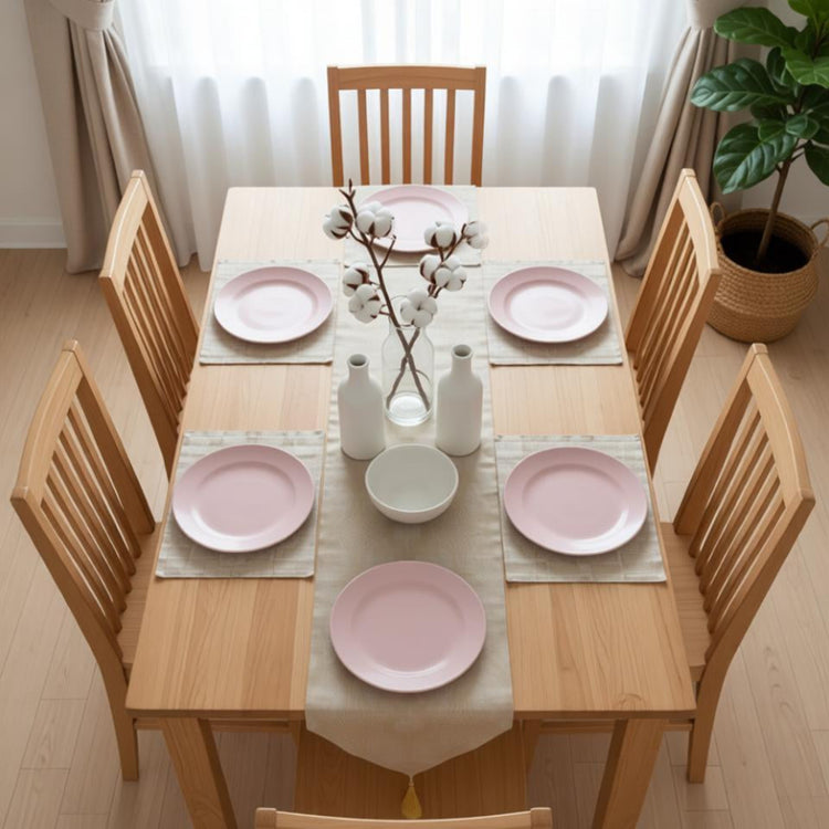 Pale gold patterned table runner with matching placemats.