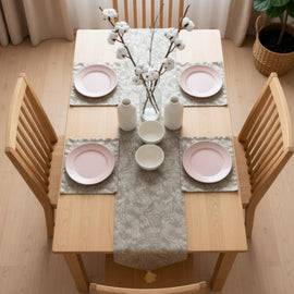 Grey ornamental table runner with matching placemats.