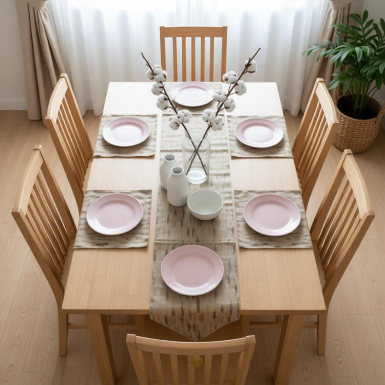 Cream table runner with grey and gold vertical motifs and matching placemats.