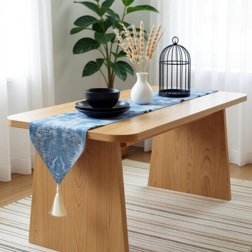 Light blue damask table runner draped over a wooden table.