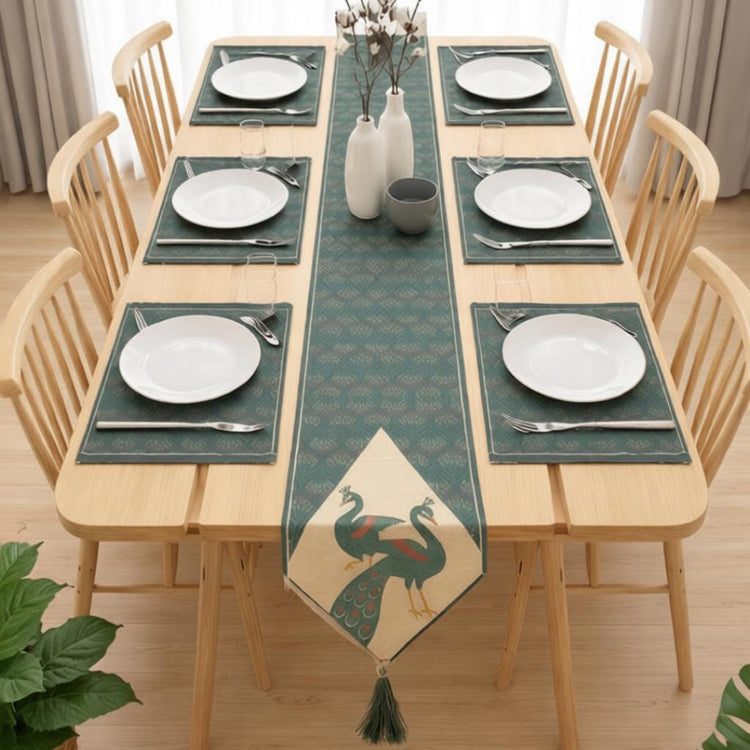 Green ornamental table runner with peacock motifs and matching placemats.