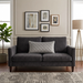 Rectangular silver grey filled cushion with diamond stitching on a dark grey sofa.
