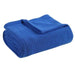 Folded royal blue ribbed cotton thermal blanket.