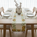 Cream sunflower table runner with green borders and matching placemats.