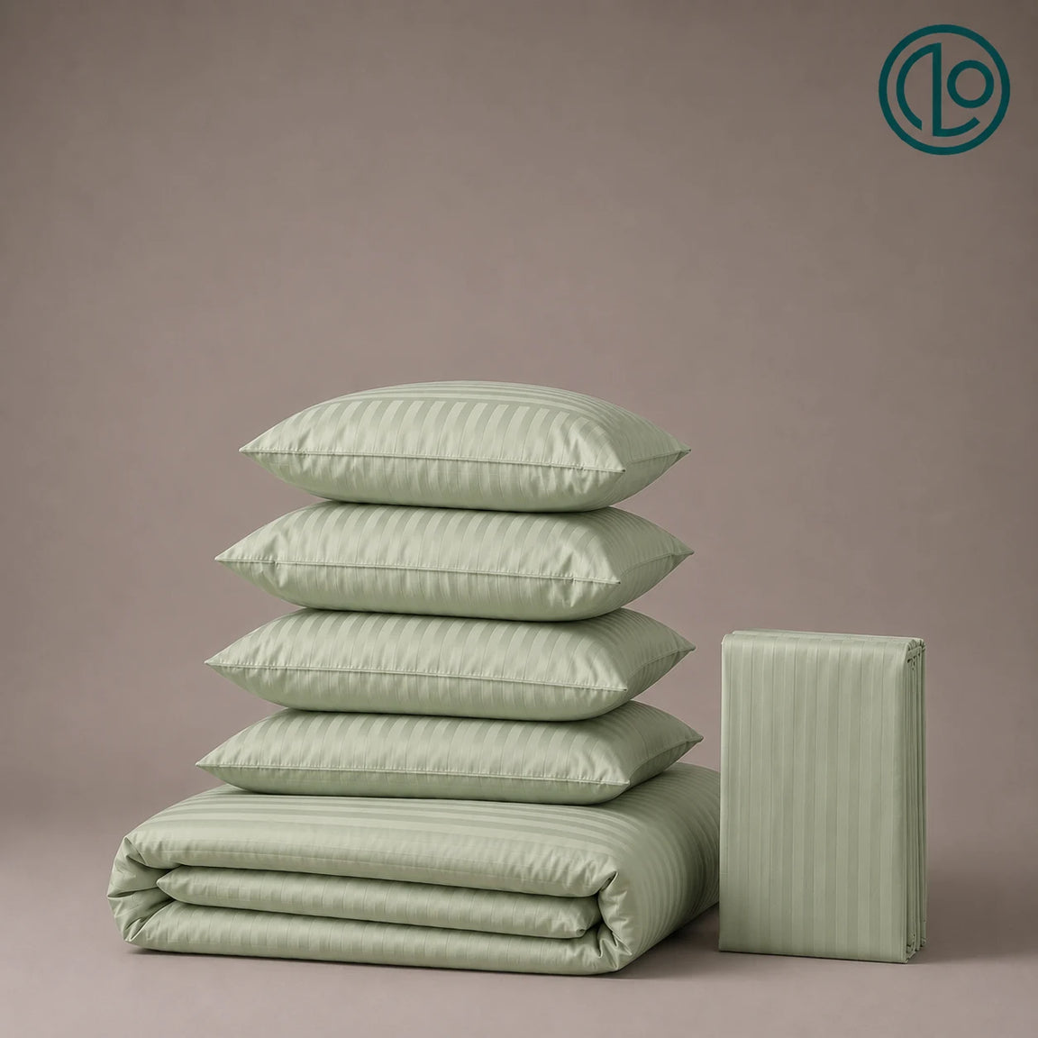 Stacked sage green striped pillowcases and folded bed linen.