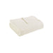 Folded cream ribbed cotton thermal blanket.