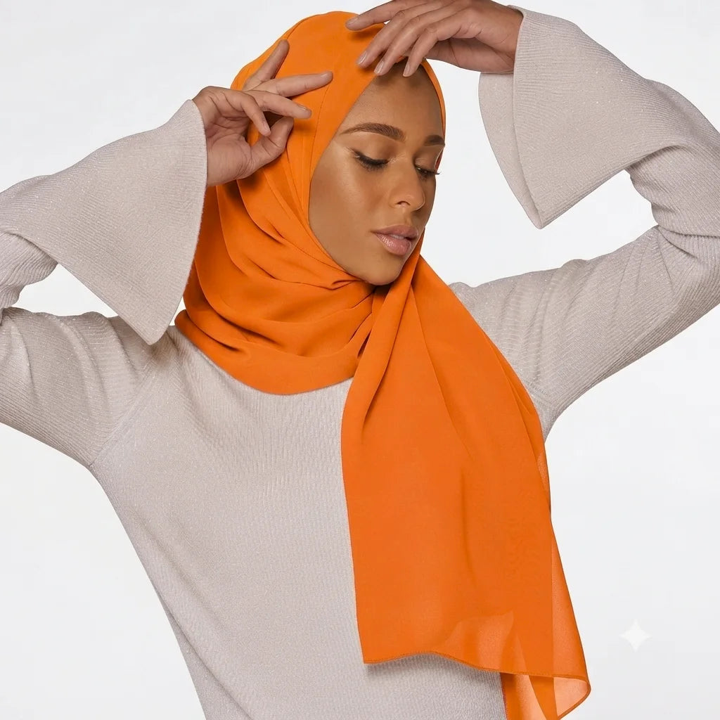 Model wearing a plain orange chiffon stole as a headscarf.