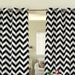 Black and white chevron eyelet curtains hanging at a window.