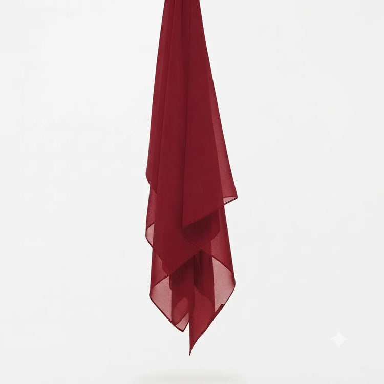 Burgundy chiffon stole hanging vertically to show its light fabric.