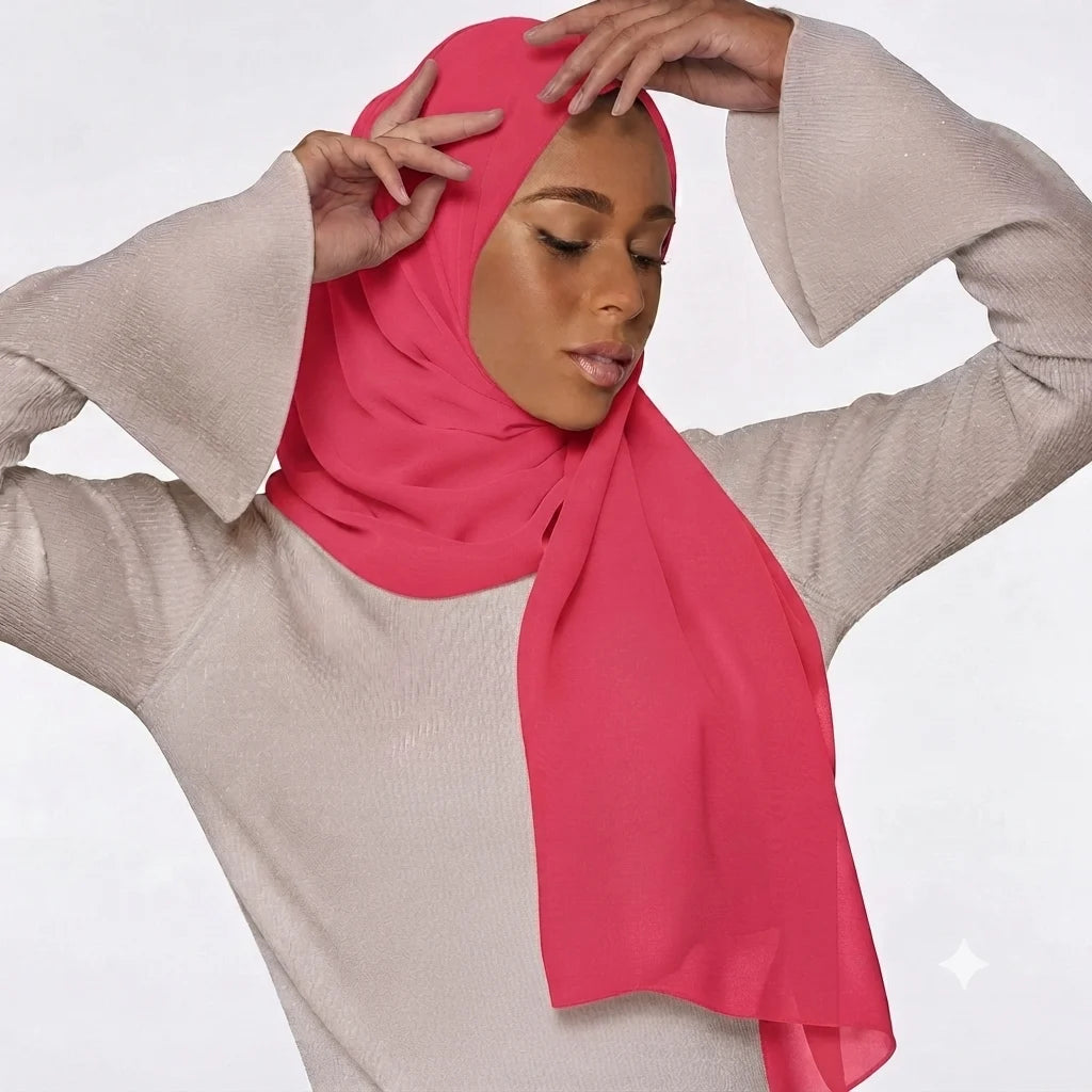 Model wearing a plain bright pink chiffon stole as a headscarf.