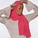 Model wearing a plain bright pink chiffon stole as a headscarf.