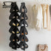 Black and grey hanging shoe organizers filled with shoes on a wardrobe rail.