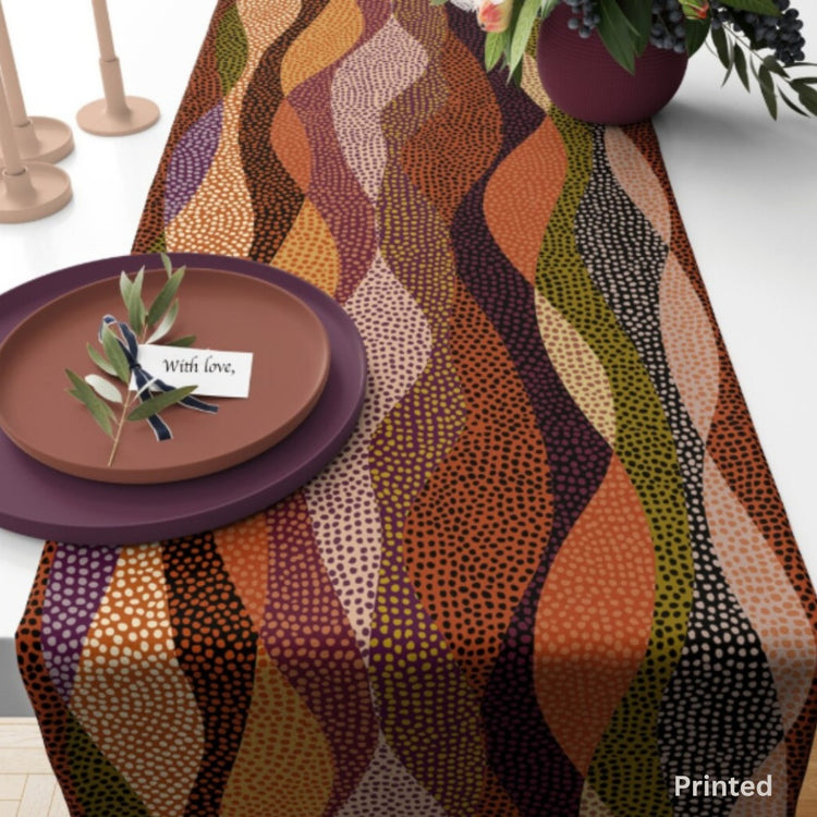 Close-up of multicoloured curved bands and dotted motifs on a table runner.