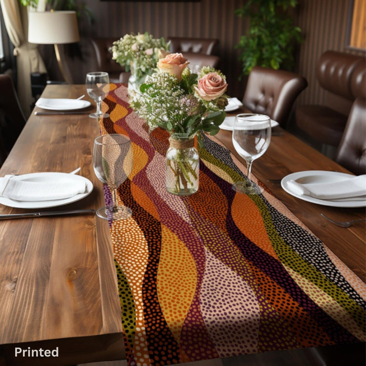 Table runner with curved dotted bands in warm orange, brown, mustard and purple.