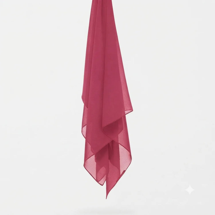Bright pink chiffon stole hanging vertically to show its light fabric.