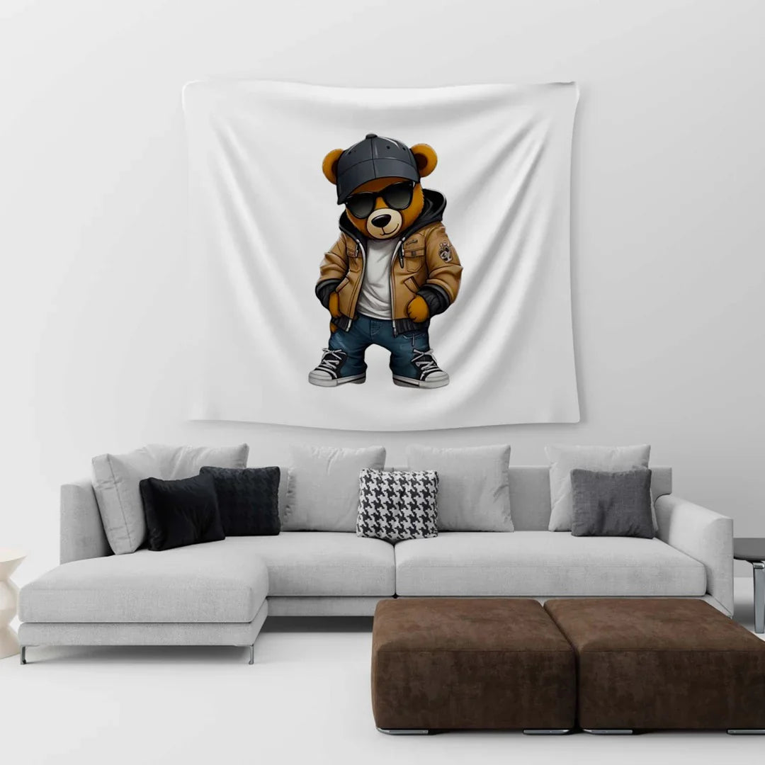 White wall tapestry with a dressed teddy-bear illustration above a sofa.