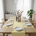Yellow and white striped table runner with matching placemats.