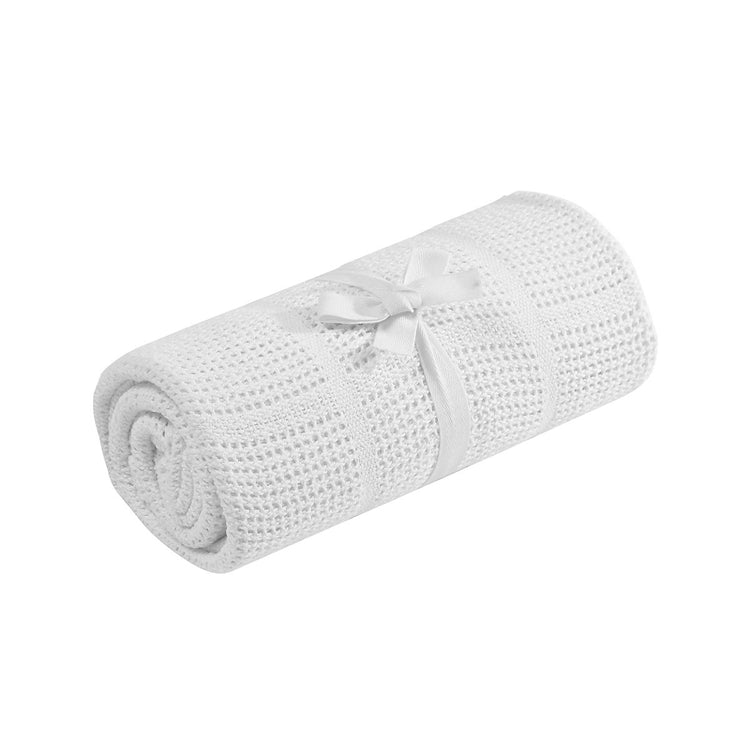 Rolled white cellular blanket tied with a white ribbon.