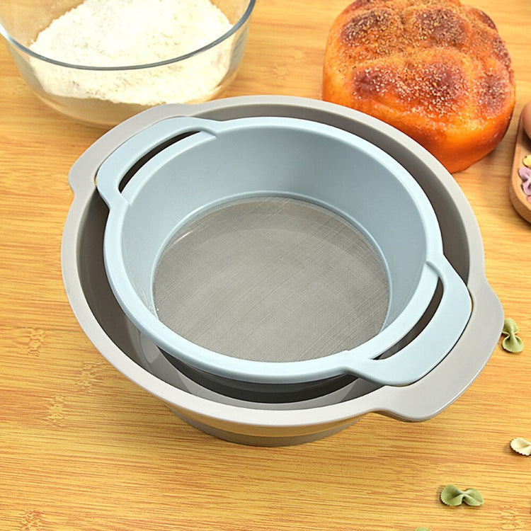 Grey-blue flour sieve nested inside a matching bowl on a kitchen counter.
