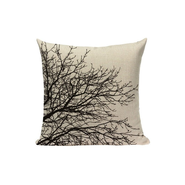 Cream cushion cover with bare black tree branches spreading from one side.