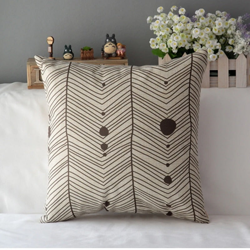 Cream cushion cover with grey chevrons and small heart motifs.