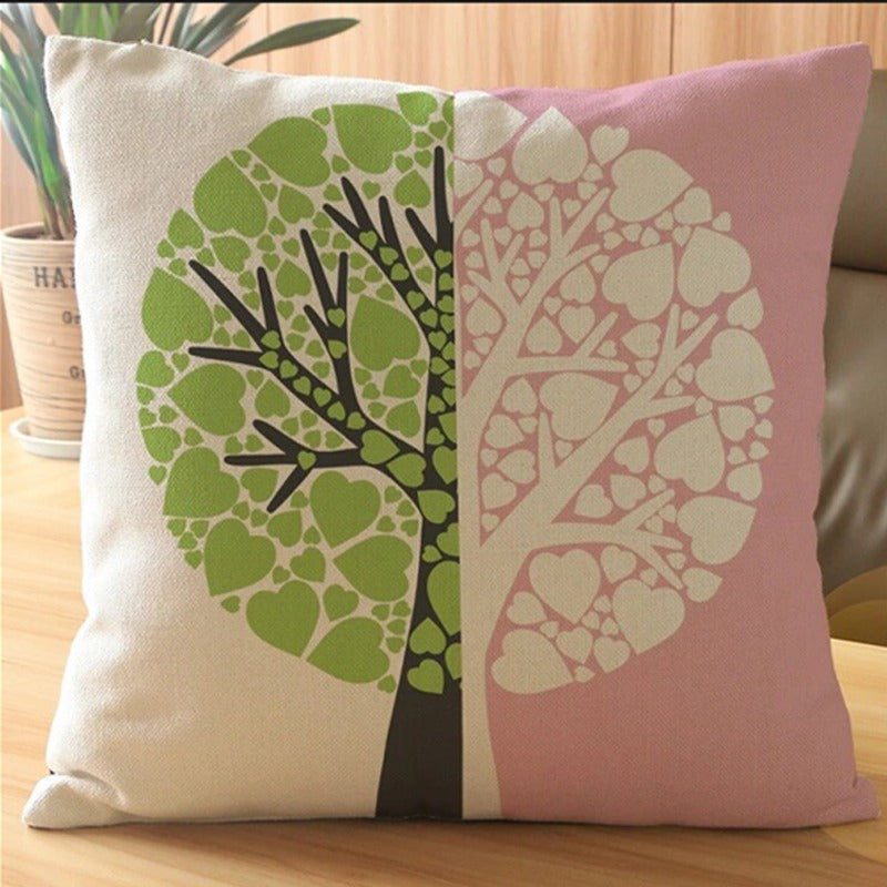 Cream and pink cushion cover with a split green and pale pink tree design.