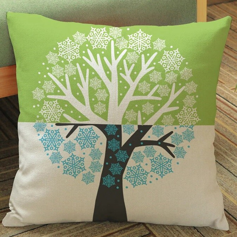 Green and cream cushion cover with a large tree and white snowflake-shaped motifs.