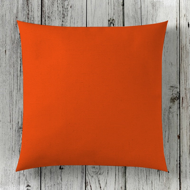 Plain orange cushion cover displayed against wooden boards.