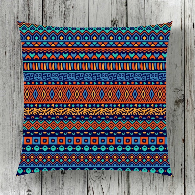 Cushion cover with narrow horizontal bands of colourful geometric motifs.