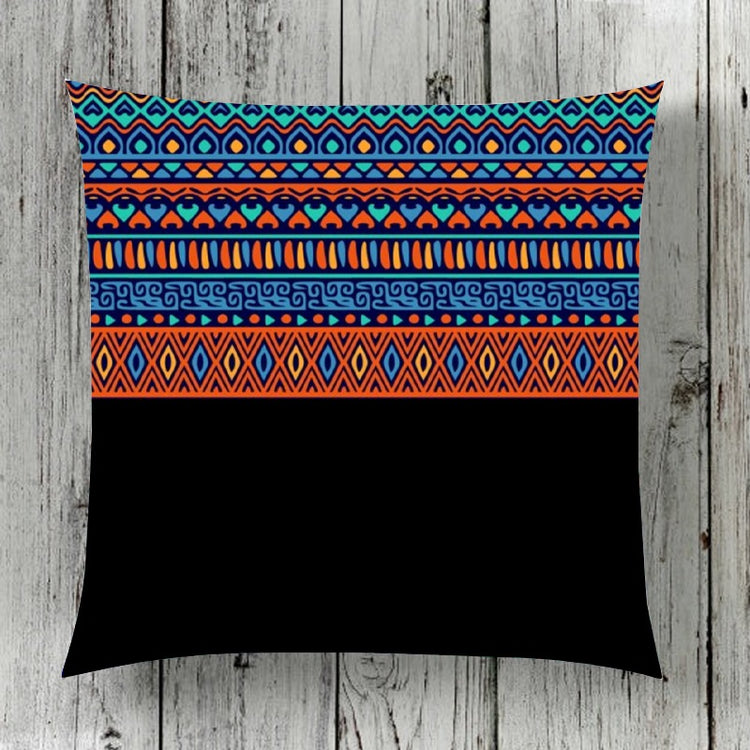 Cushion cover with colourful geometric bands above a solid black lower panel.