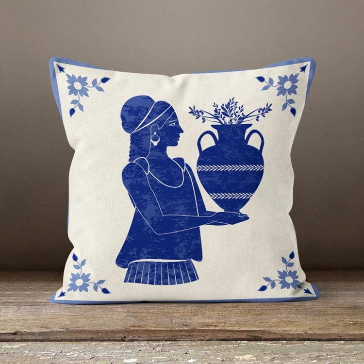 Cream cushion cover with a blue figure holding a large pot.