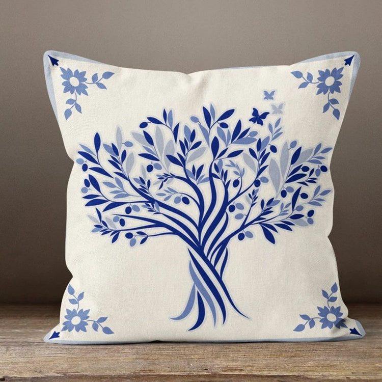 Cream cushion cover with a blue leafy tree and floral corner details.