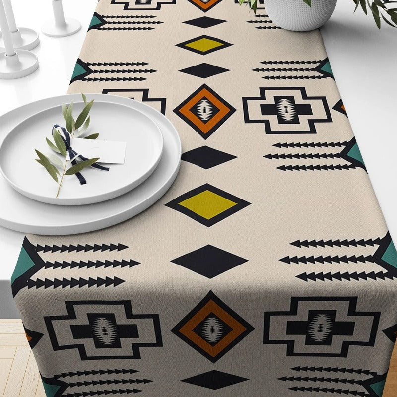 Cream table runner with black geometric lines and coloured diamonds.