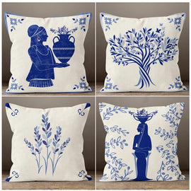 Four cream cushion covers with blue botanical and figure illustrations.