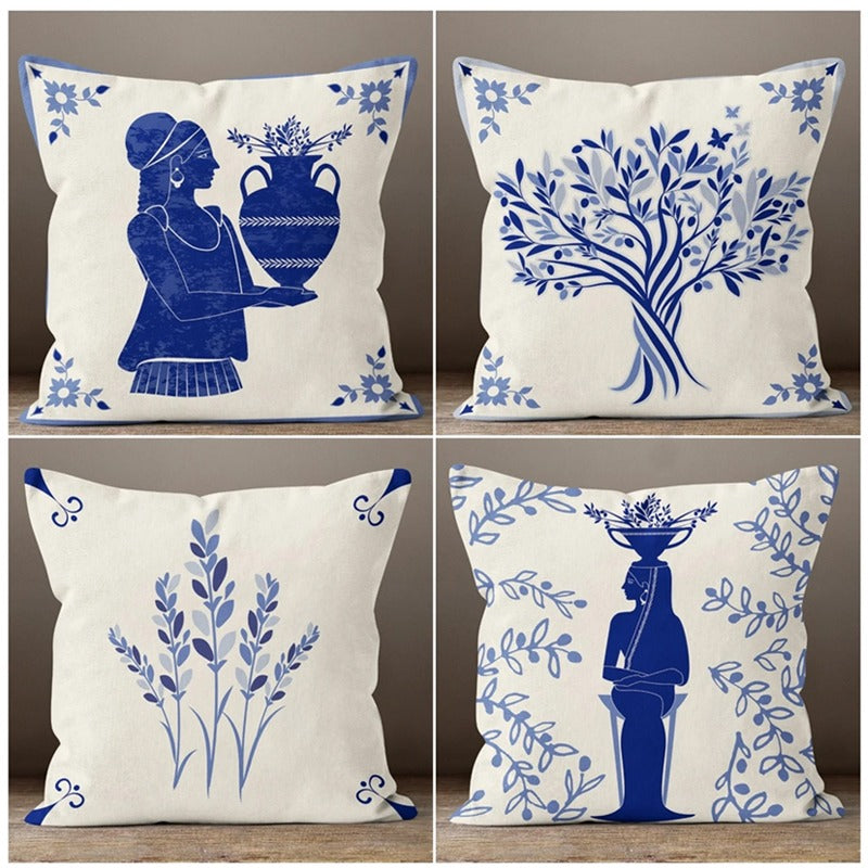 Four cream cushion covers with blue botanical and figure illustrations.