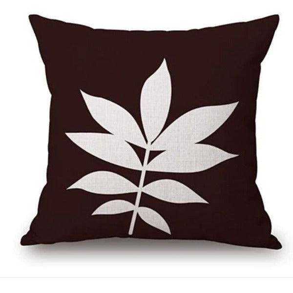 Dark brown cushion cover with a white leafy stem.