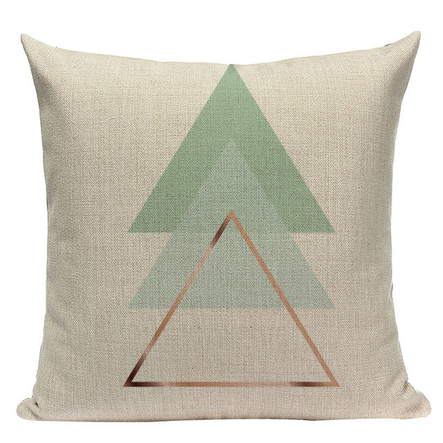Cream cushion cover with overlapping mint triangles and a rust triangle outline.