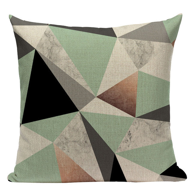 Cushion cover with irregular mint, grey, brown and black polygon shapes.