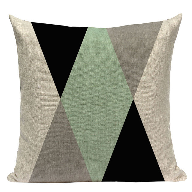 Cushion cover with large mint, grey, cream and black triangles.