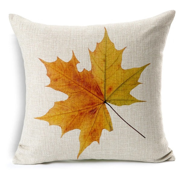 Cream cushion cover with an orange and yellow maple leaf.