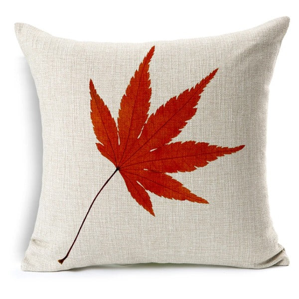 Cream cushion cover with a red pointed autumn leaf.