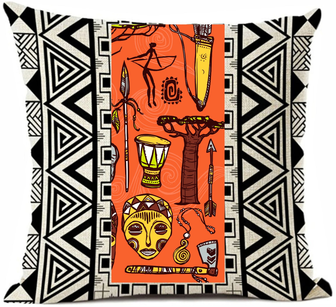 Cushion cover with an orange mask and figure panel between black and white geometric borders.