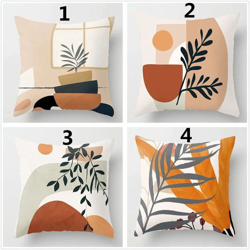 Four neutral cushion covers with abstract botanical designs in terracotta, beige and black.