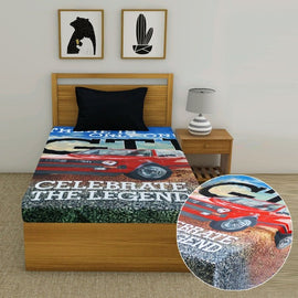 Children's bedsheet with a red sports car print displayed on a single bed.