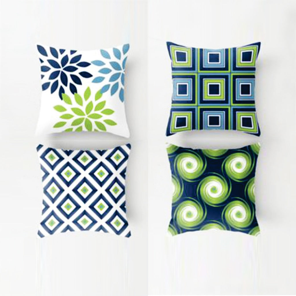 Four cushion covers with blue, green and cream botanical and geometric designs.