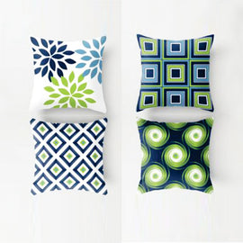 Four cushion covers with blue, green and cream botanical and geometric designs.