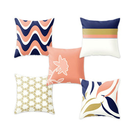 Five cushion covers with navy, coral, mustard and cream abstract patterns.