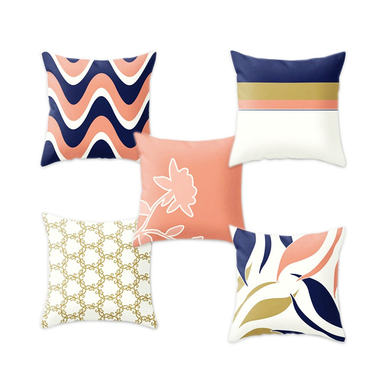Five cushion covers with navy, coral, mustard and cream abstract patterns.