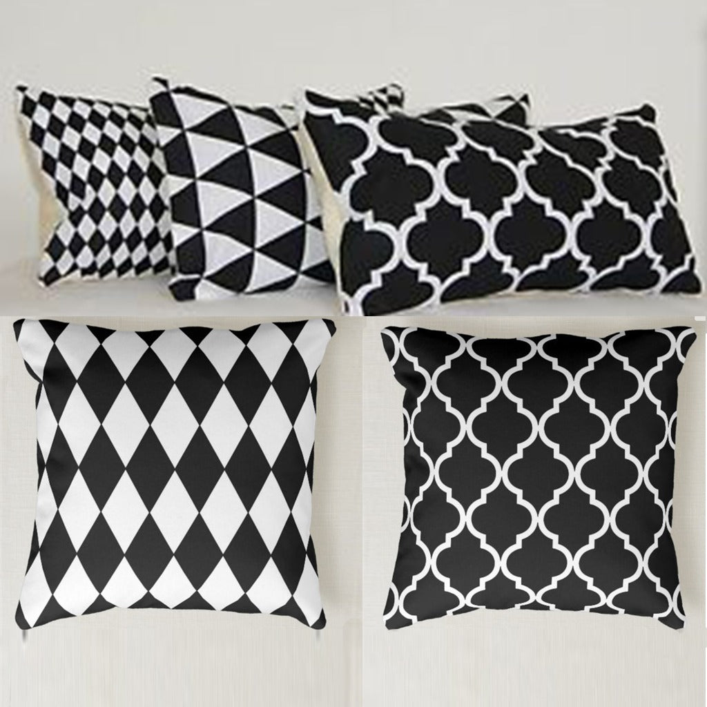 Five black and white cushion covers with assorted geometric patterns.